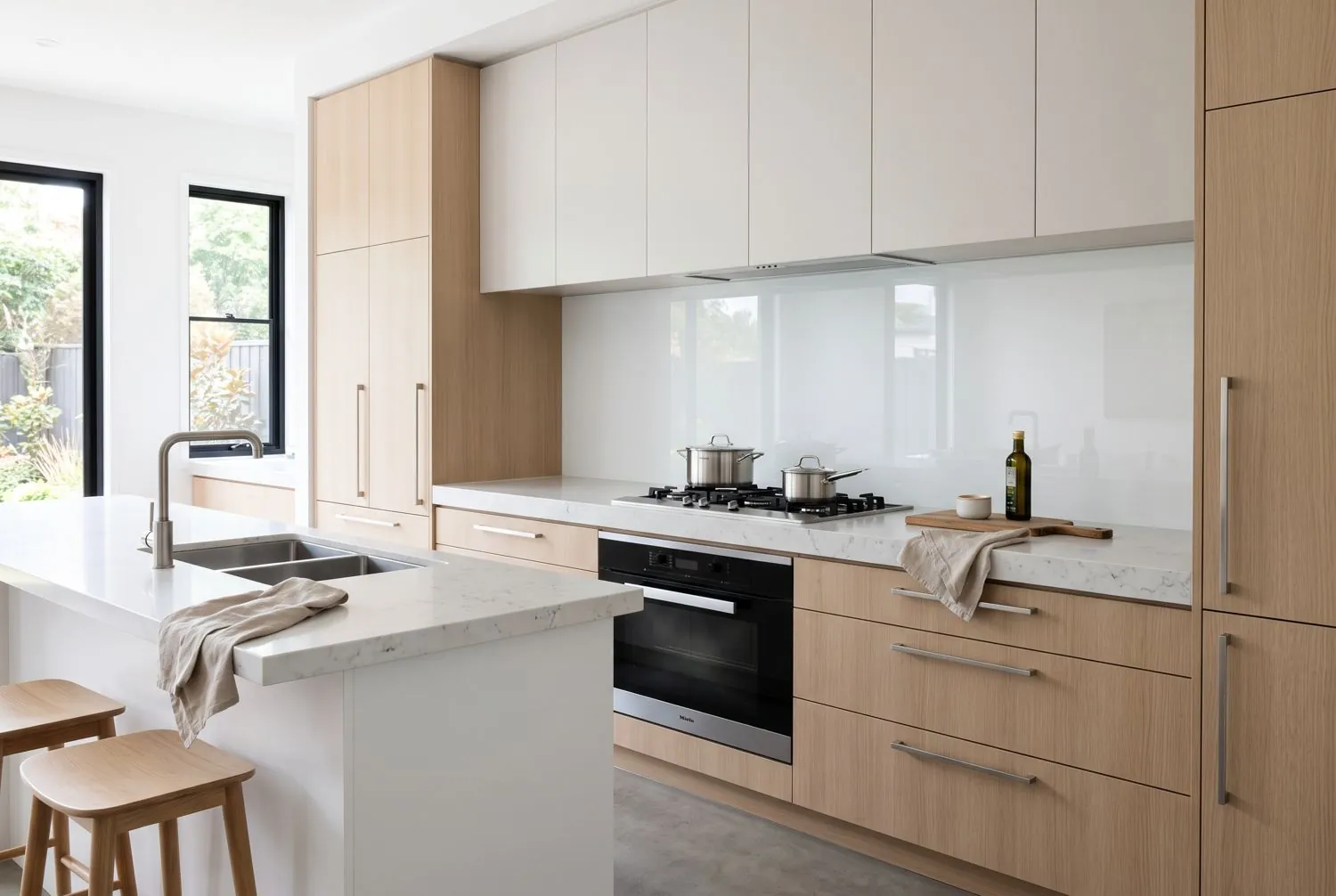 Kitchen with a white glass splashback